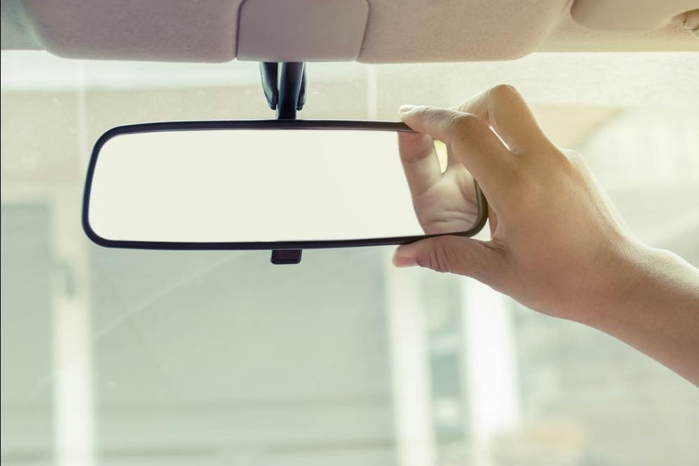 What Does That Tab on Your Rear View Mirror Really Do?