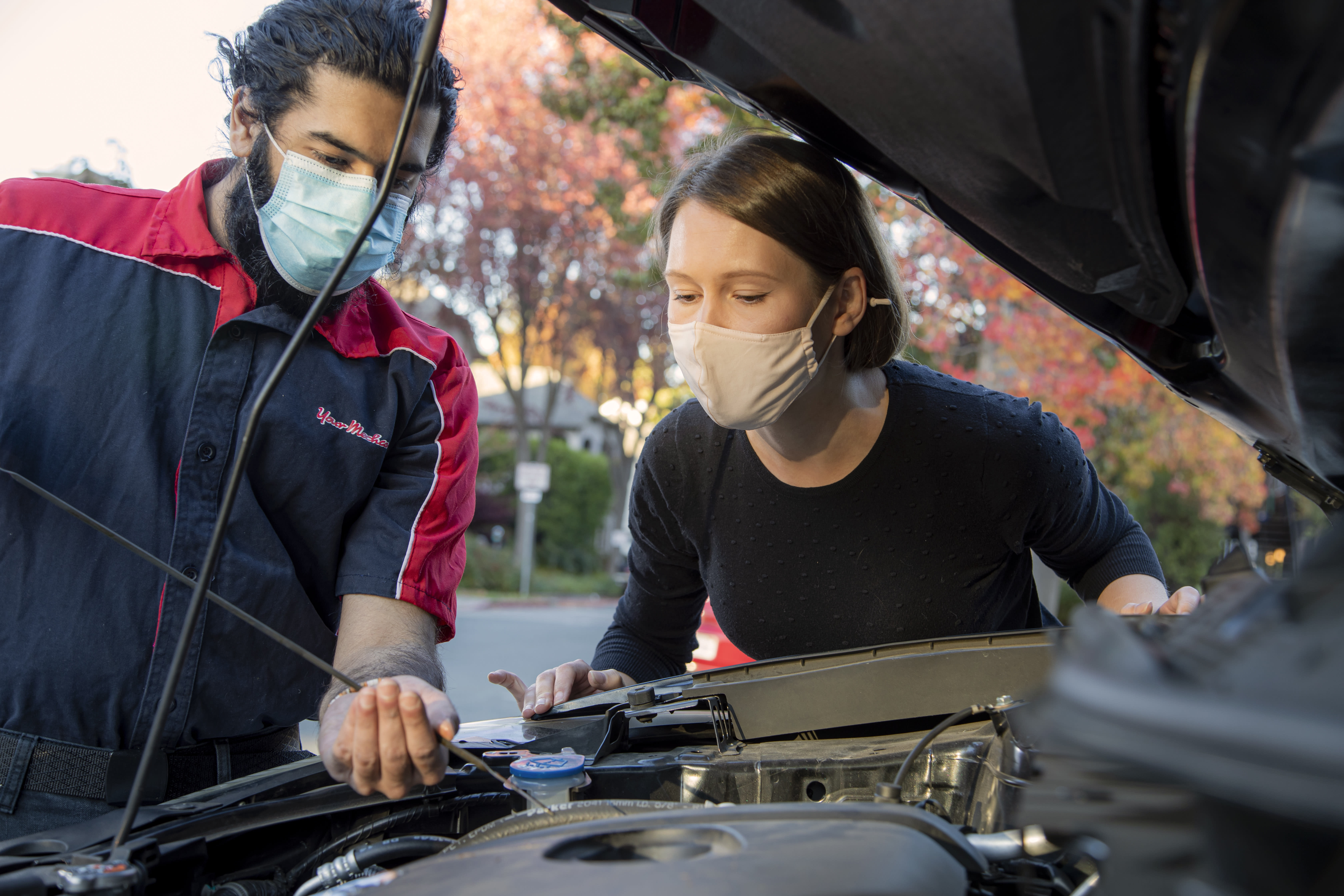 Mobile mechanic repairing a car at a customer