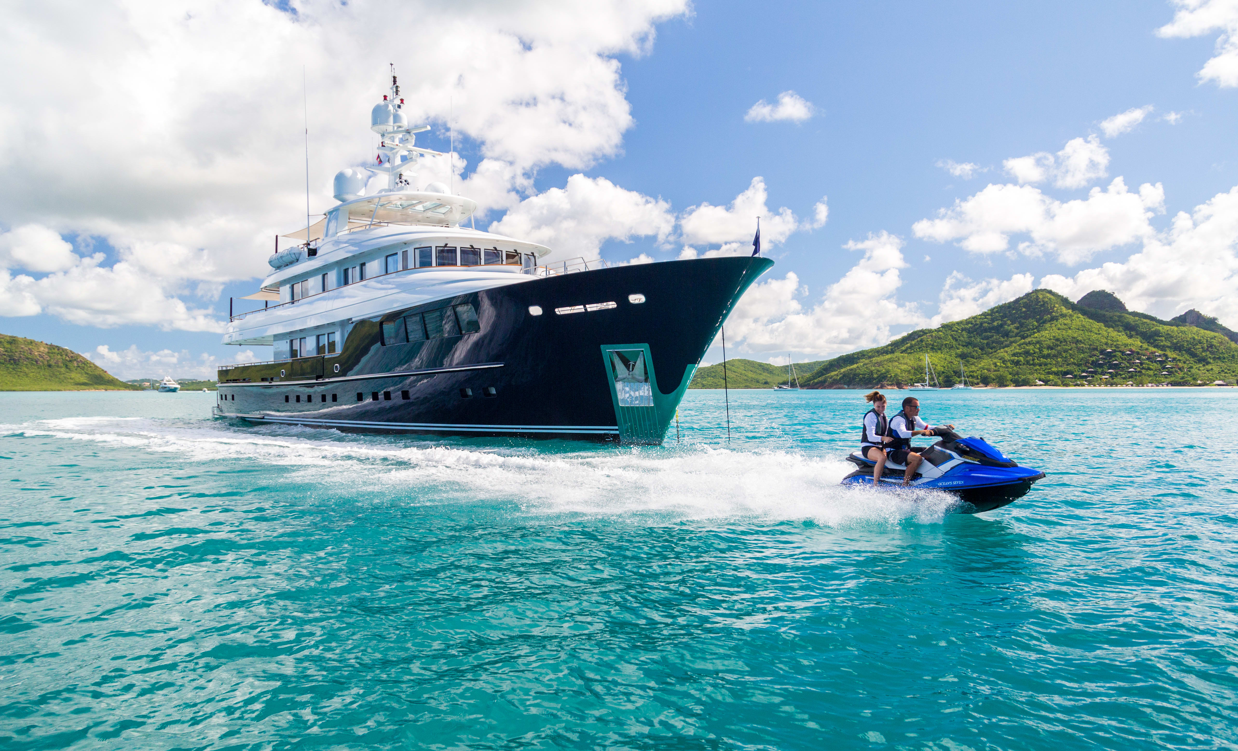 Ocean' Seven superyacht for charter and a guest on a jet ski