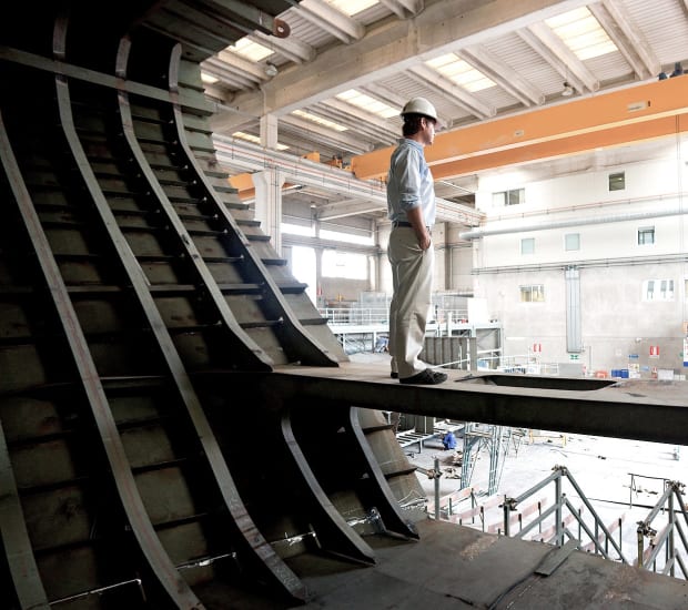 Worker inspects yacht in the shipyard