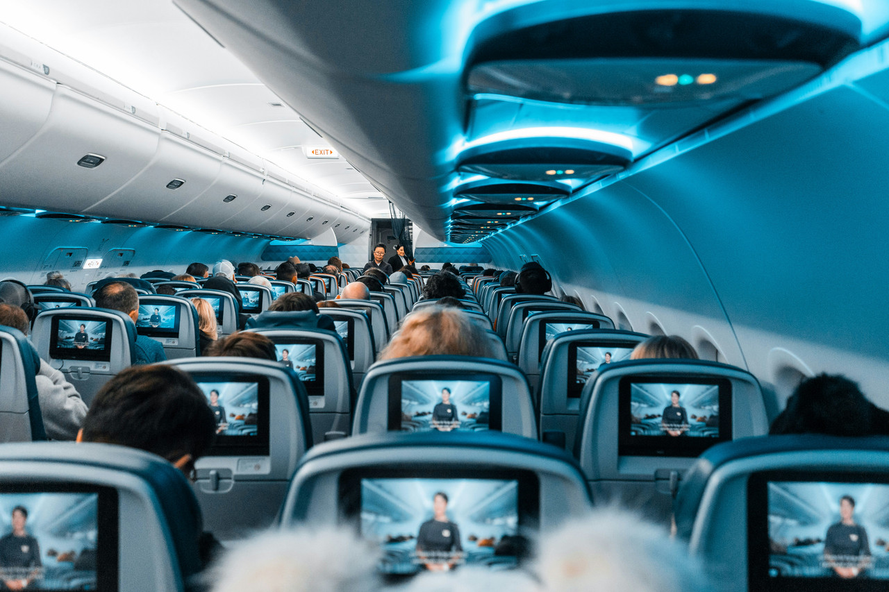 Luxury airline cabin interior with white leather seats