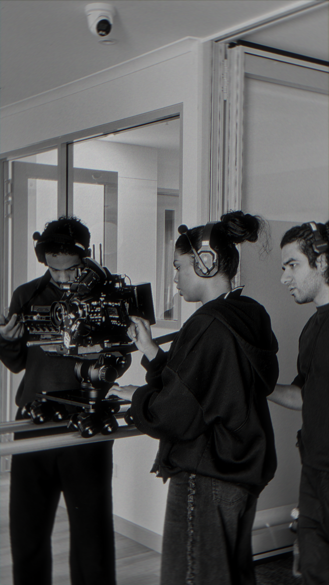 First assistant camera focus puller adjusting wireless follow focus beside cinema rig