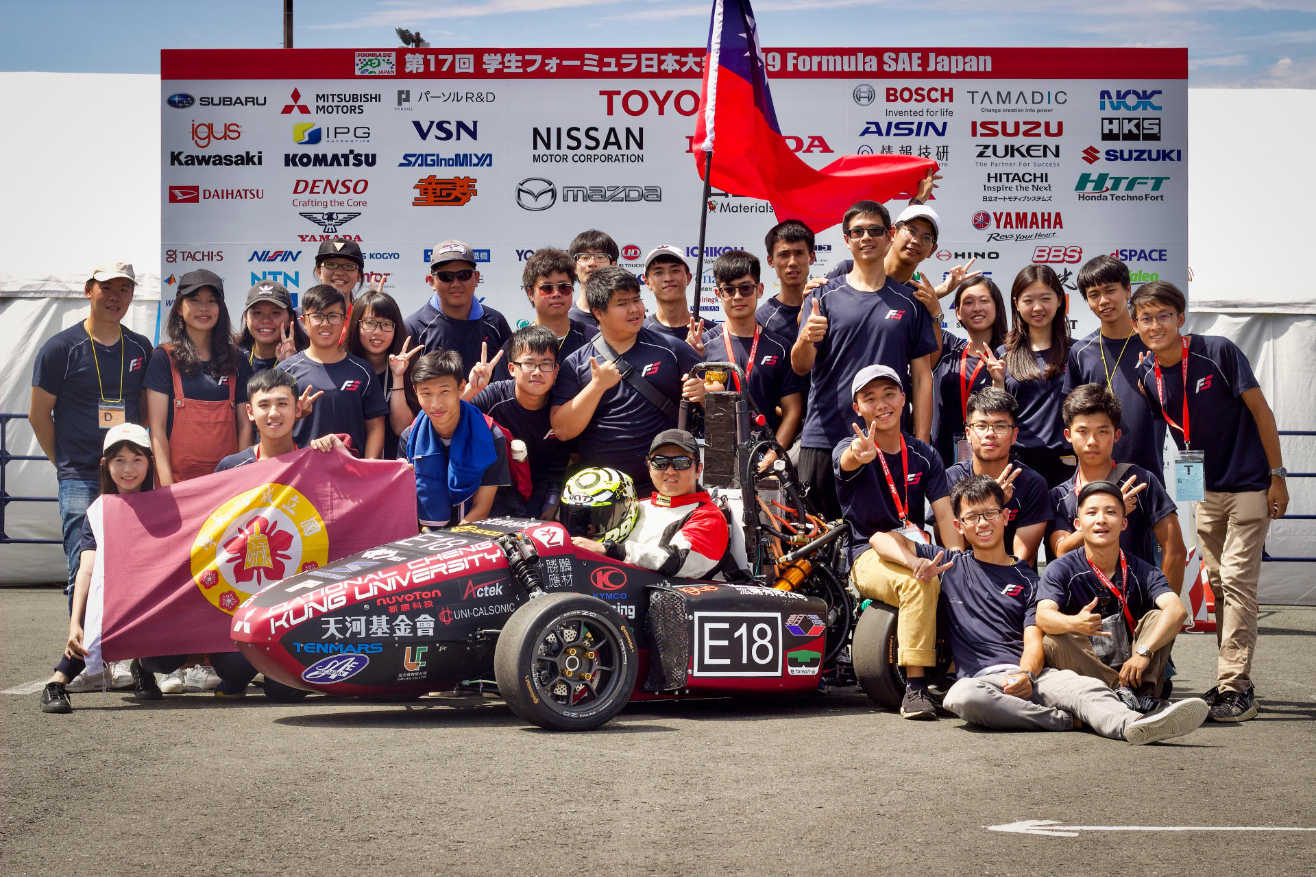 Team photo shot at competition site.