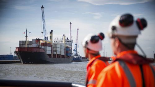 two men in hard hats by Port of hull,