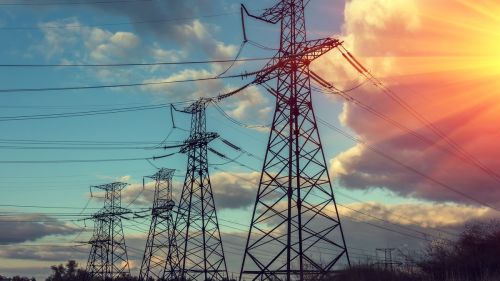 Power cables against a colourful sky