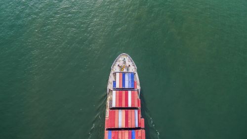 aeriel view container shipping by container ship by green sea .