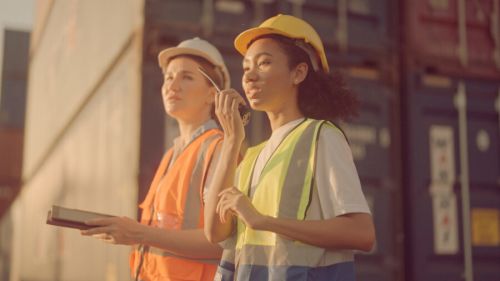 Two Female Shipping Working And Checking Container In The Port