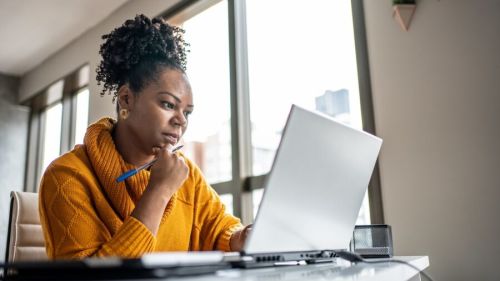 Woman at desk considering career change