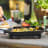 Ooni Cast Iron Sizzler Pan on the table with food