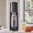 Sodastream Terra Sparkling Water Maker - Black with a glass of sparkling water