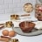Trendz Of Today Gold & Wood Measuring Cup and Spoon Set on the kitchen counter with eggs and other ingredients