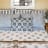 India Ink Blue Feather Paisley Quilt - Double on the bed