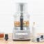 Magimix Compact 1100W Food Processor, 5200XL - Satin on the table