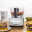 Magimix Compact 1100W Food Processor, 5200XL - Satin on the table