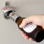 KitchenCraft Wall Mounted Crown Bottle Opener opening a beer bottle