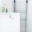 Brabantia Tower Drying Rack, 23m - Metallic Grey next to the basin