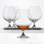 Spiegelau Lead-Free Crystal Vino Grande Cognac Glasses, Set of 4 on the table with whiskey in one glass