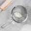 MasterClass Stainless Steel Fine Mesh Sieves 18cm with flour next to a rolling pin