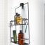 Umbra Cubiko Metal Shower Caddy on the shower glass with toiletries