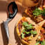 Dreamfarm Scizza Pizza Cutter & Lifter - Black on the table with pizza