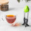 Dreamfarm Teafu Tea Infuser - Green with a cup of tea