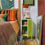 Popstrukt Sugar Cube Side Table - Cyber Lime next to the bed