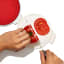 Action image of OXO Good Grips Cut & Keep Silicone Tomato Saver