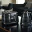 DeLonghi Avvolta Class 4-Slice Toaster, 1800W - Black with a kettle on the table