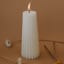 Lifestyle image of Okra Candle Off White Gear-Shaped Candle