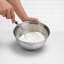 Brabantia Matt Steel Mixing Bowl - 1.6L with cream and a whisk