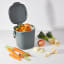 Filled OXO Good Grips Easy-Clean Compost Bin Charcoal - 2.83 L next to vegetables 