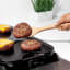 Flipping a burger with the OXO Wooden Spatula