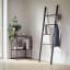 Umbra Leana Display Ladder - Black with jackets and a cap 