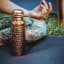 Coppa Wellness Hammered Copper Water Bottle, 750ml in use 