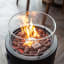 Alva Gas Fire Pit with Lava Stones in use 