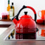 Le Creuset Peruh Whistling Stovetop Kettle, 1.6L on the stove