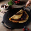 Victoria Seasoned Cast Iron Pizza Pan with Helper Handles, 38cm in use