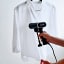 SteamOne Handheld 150ml Garment Steamer steaming a white shirt