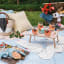 Drop in the Ocean Pretty Picnics Large Picnic Blanket with a wooden picnic table, cocktails and snack board 