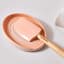 Le Creuset Peche Craft Medium Spatula on the table