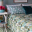 India Ink Aqua Temple Garden Kantha Stitched Throw - Single on the bed