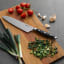 Sagenwolf Performance Chef's Knife, 21cm on a wooden board with sliced chives 