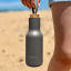 Sengetti Hydra Water Bottle - Charcoal by the beach