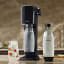 Sodastream Art Sparkling Water Maker - Black with carbonating bottles and a glass of sparkling water
