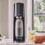 Sodastream Terra Sparkling Water Maker - Black with a glass of sparkling water