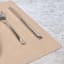 Lind DNA Nupo Leather Square Leather Table Mat - Sand on the table with cutlery