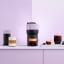 Nespresso Vertuo Pop Coffee Machine - Lilac on the table with coffee