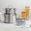 Sagenwolf Silver Series Stainless Steel Saucepan with Glass Lid, 16cm on the kitchen counter with other pots and pans