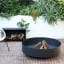 Sprung Outdoor Living Round Fire Pit in a garden