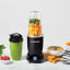 Nutribullet Pro+ 1200W High Speed Blender on the table with vegetables and a bowl of soup